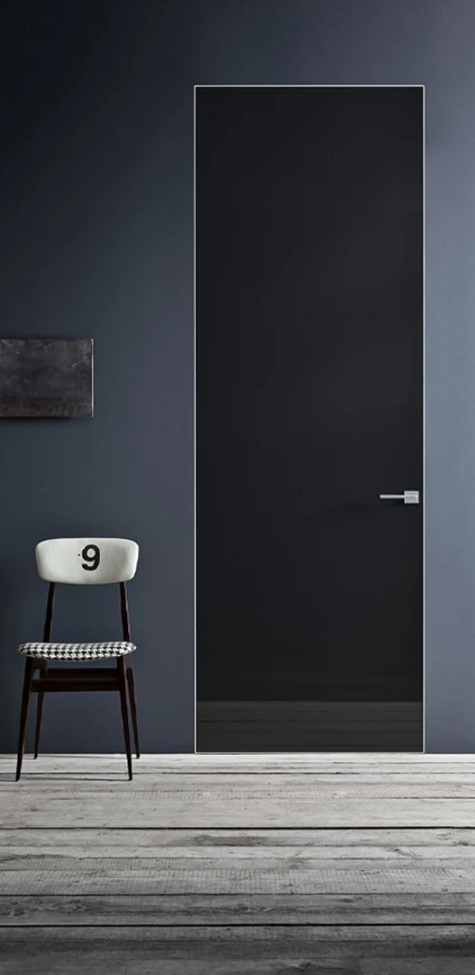 Black door with a chair and number 9 on a gray floor and wall.