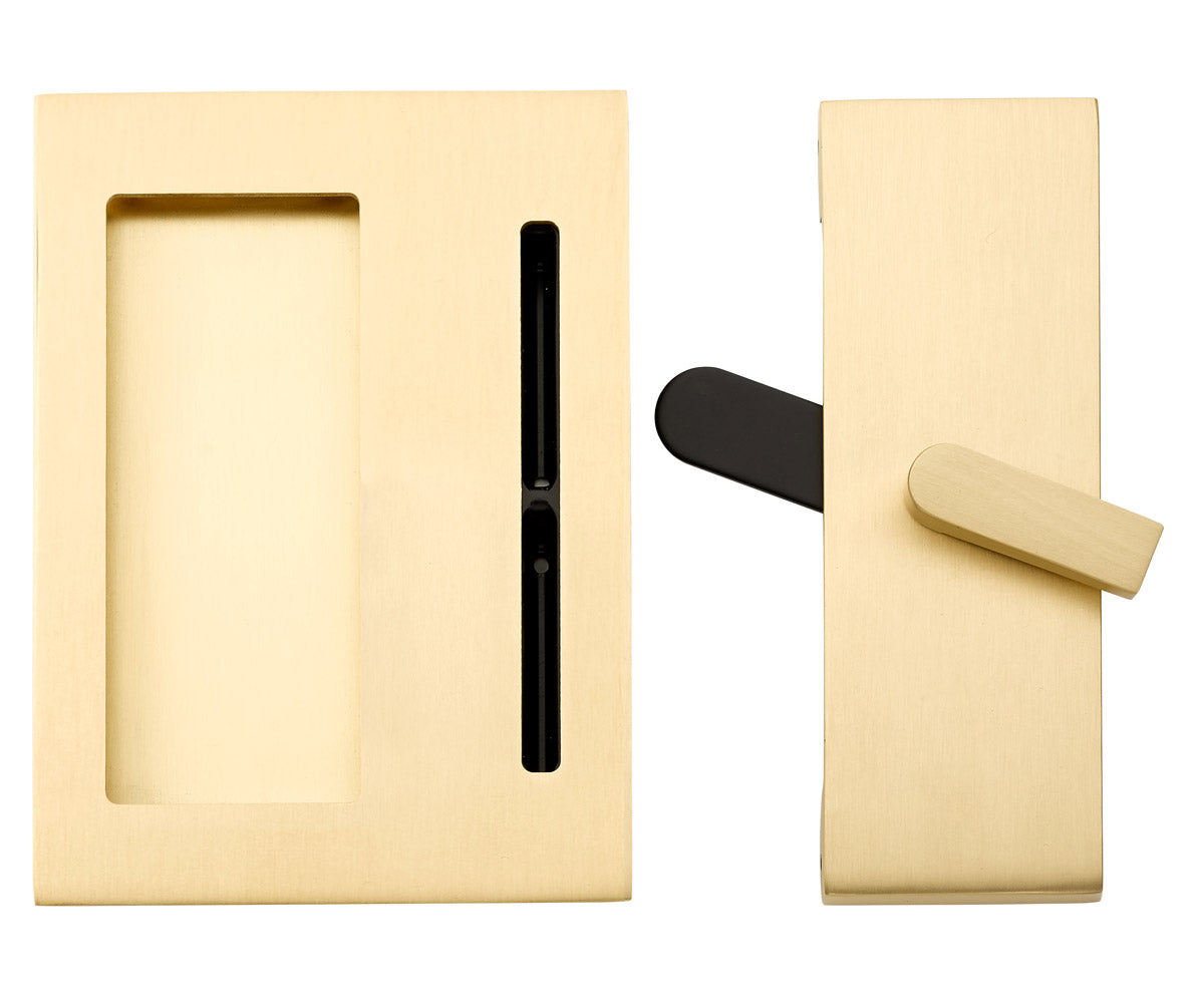 Brass pocket door hardware with a black latch and a brass pull handle