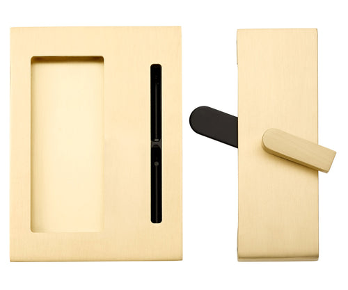 Brass pocket door hardware with a black latch and a brass pull handle