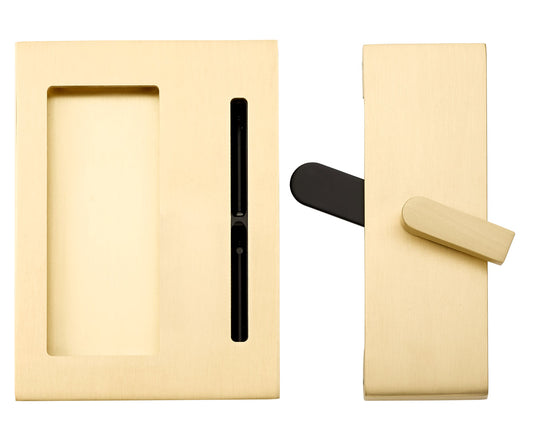 Brass pocket door hardware with a black latch and a brass pull handle