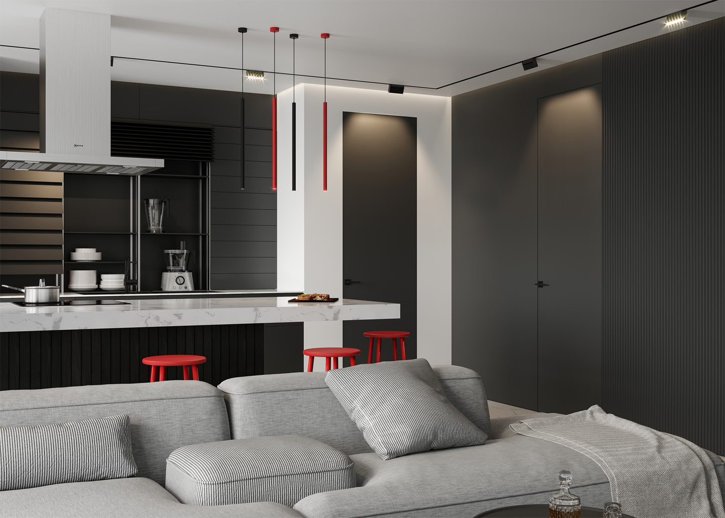 Modern kitchen and living room with gray sofa, red stools, and black and white decor